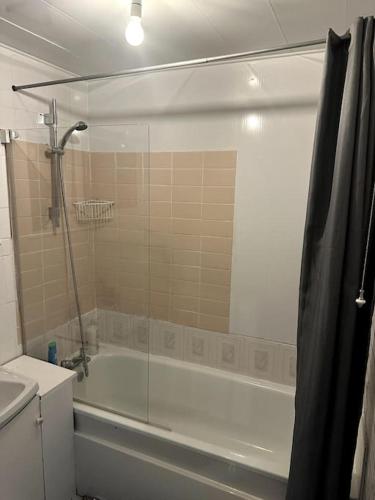 a bathroom with a shower and a tub and a sink at Entire 2 bed home, North Shields, UK FREE parking in North Tyneside