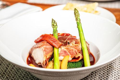 a bowl of food with meat and vegetables on a table at Sheraton Guayaquil in Guayaquil