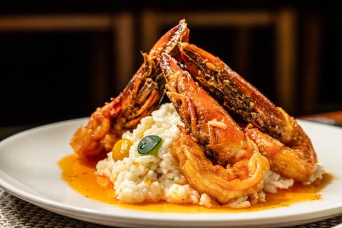 a plate of food with shrimp and rice on a table at Sheraton Guayaquil in Guayaquil