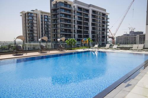 a large swimming pool on top of a building at Chic 1 Bedroom in Privé Residence, Dubai Hills in Dubai