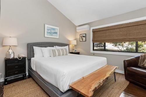 a bedroom with a bed and a couch and a window at White Oak 51 with Wintergreen Advantage in Wintergreen