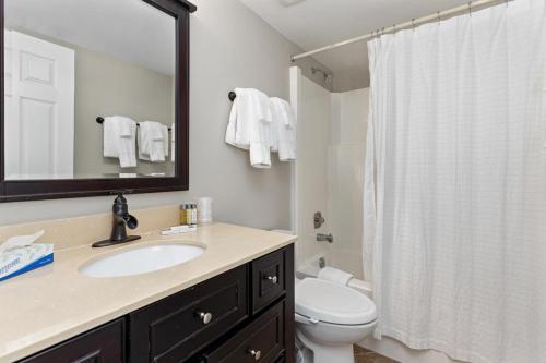 a bathroom with a sink and a toilet and a mirror at White Oak 51 with Wintergreen Advantage in Wintergreen