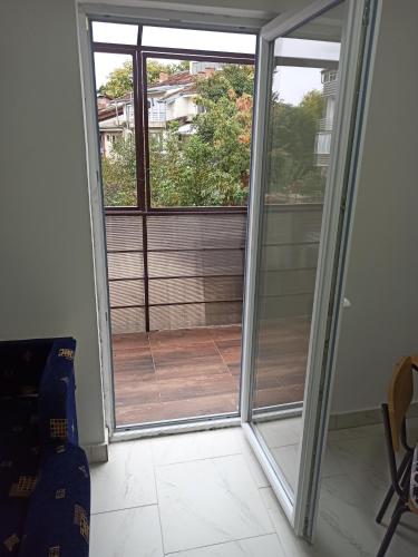 a sliding glass door with a view of a balcony at Beograd, Oaza Palilula, 2 in Borča