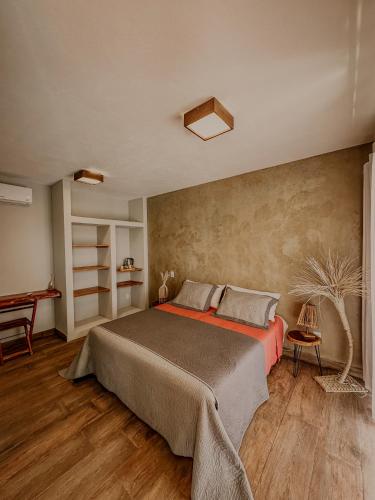 a bedroom with a large bed and a table at La Maison Loosaï - Quarto em Pousada sem TV in Itacaré