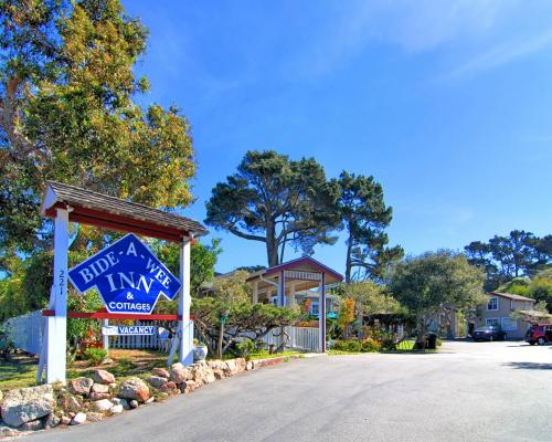 a sign for a inn in a street at Bide-A-Wee Inn and Cottages in Pacific Grove