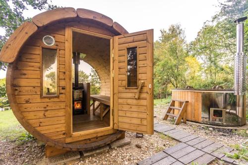 a wooden hobbit house with an arched doorway at ENJOY COZY NEST View Hills Garden Forest Sauna Hottub in Jablonné v Podještědí