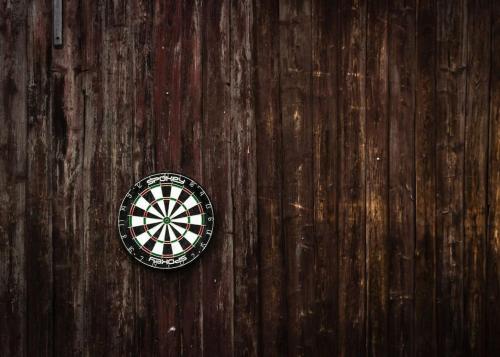 a dartboard sitting on top of a wooden table at ENJOY COZY NEST View Hills Garden Forest Sauna Hottub in Jablonné v Podještědí