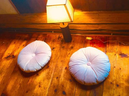 two white bean bags on the floor next to a lamp at ENJOY COZY NEST View Hills Garden Forest Sauna Hottub in Jablonné v Podještědí