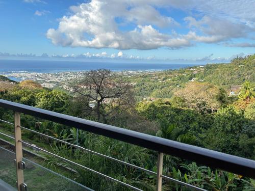 a view of the ocean from the balcony of a house at Cosy Vaikea Lodge, Pamatai road in Faaa