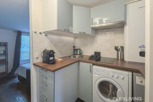 une cuisine avec une machine à laver et un évier dans l'établissement Flexliving - Studio - Martyrs, à Paris