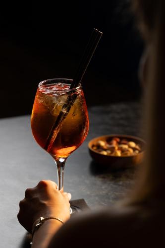 a woman is holding a glass with a drink at Onyour Dreams Belek in Belek