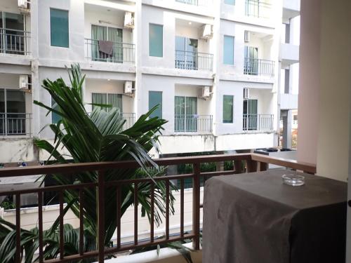 a balcony of a building with a table and a plant at Central Patong apartment at Phuket Villa in Patong Beach