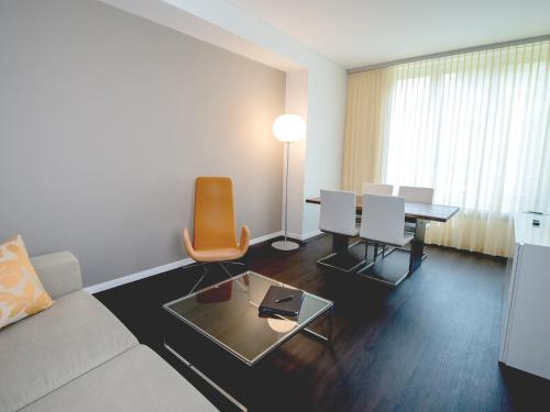 a living room with a couch and a table at Park Hotel Zug in Zug