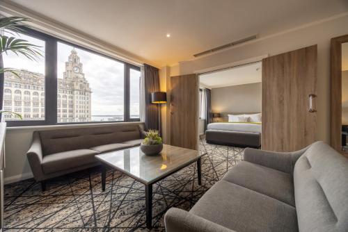 a living room with a couch and a bed at Crowne Plaza Liverpool City Centre by IHG in Liverpool