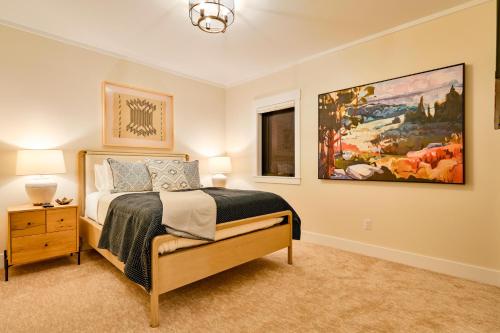 a bedroom with a bed and a painting on the wall at 6-Cottage Bundle at Academy Place in Crested Butte