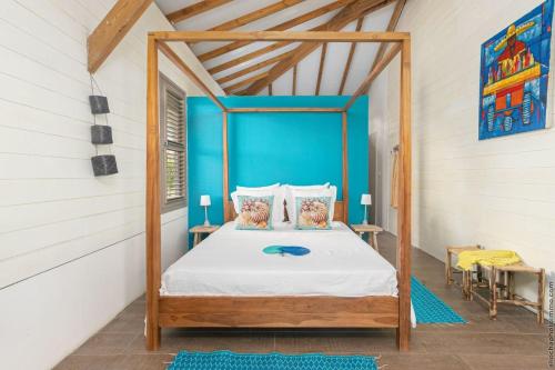 a bedroom with a canopy bed in a room at Villa moderne avec piscine à Le Vauclin in Le Vauclin