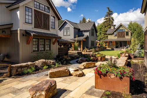 a yard with rocks and a house at Academy Place | Bluebell in Crested Butte
