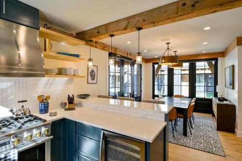a kitchen with blue cabinets and a large kitchen island at Academy Place | King's Crown in Crested Butte