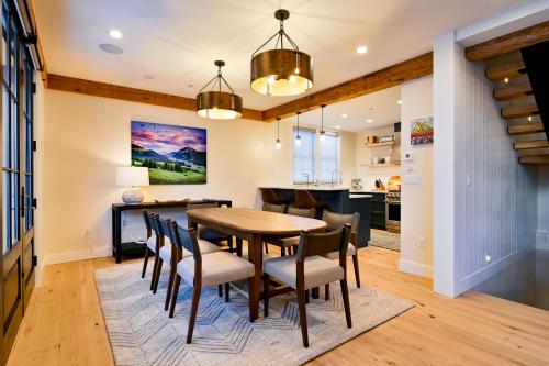 a kitchen and dining room with a wooden table and chairs at Academy Place | Bluebell in Crested Butte