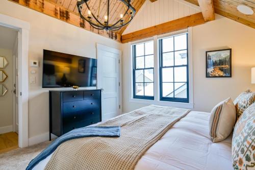 a bedroom with a bed and a tv at Academy Place | Bluebell in Crested Butte