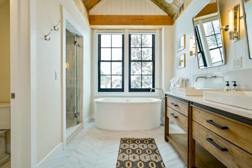 a bathroom with a tub and a sink at Academy Place | Bluebell in Crested Butte
