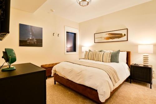 a bedroom with a large bed and a table at Academy Place | Bluebell in Crested Butte