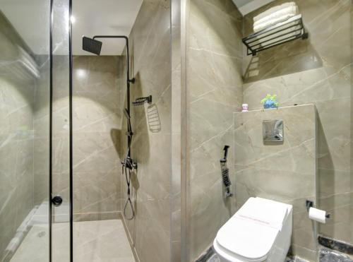 a bathroom with a shower and a toilet at HOTEL UPTOWN - Luxury Restaurant & Rooftop Near Connaught Place in New Delhi