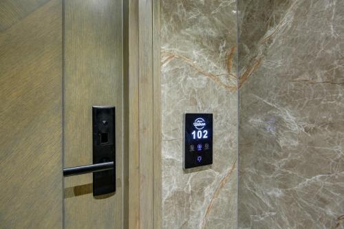 a door with a clock on a stone wall at HOTEL UPTOWN - Luxury Restaurant & Rooftop Near Connaught Place in New Delhi