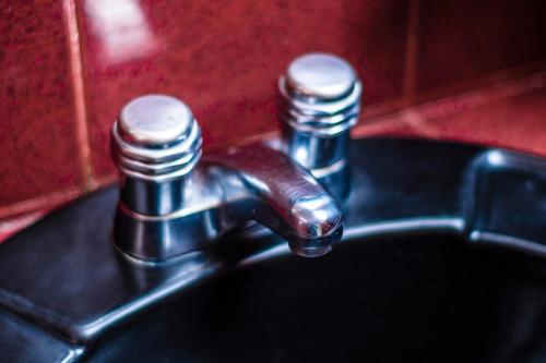 a close up of a bathroom sink with a faucet at Hotel Espor CA in Barinas
