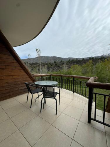 a patio with a table and chairs on a balcony at San Francisco Lodge in Los Andes