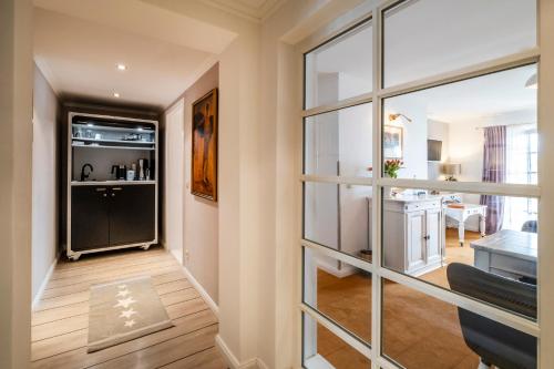 a living room with a large glass window at Seehotel Lichtenberg in Lichtenberg