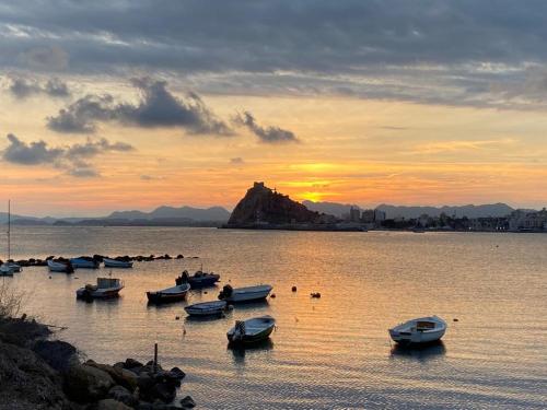 a group of boats in the water at sunset at Apartamento Isla del Fraile in Águilas