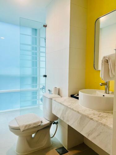 a bathroom with a toilet and a sink and a mirror at Minh Khang Hotel in Ho Chi Minh City