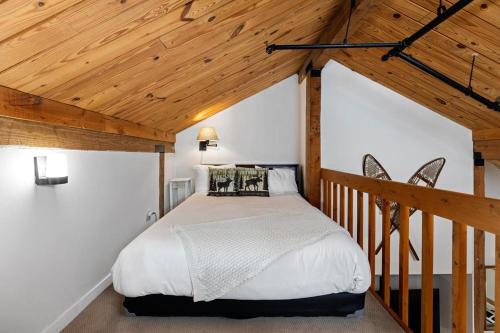 a bedroom with a bed in a room with wooden ceilings at Mountain Inn Studio 53 with Wintergreen Advantage in Wintergreen