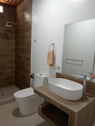 a bathroom with a sink and a toilet and a shower at Alojamiento CASA LUNA in Iquitos