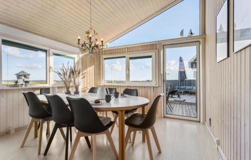 a dining room with a table and chairs at 4 Bedroom Lovely Home In Sæby in Sæby