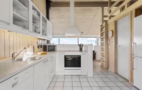a kitchen with white cabinets and a sink at 4 Bedroom Lovely Home In Sæby in Sæby