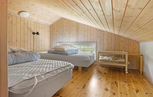 a bedroom with two beds and a wooden ceiling at Gorgeous Home In Ålbæk With Sauna in Ålbæk