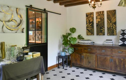a dining room with a table and a wooden cabinet at Beautiful Home In Yèvre-La-Ville in Yèvre-la-Ville