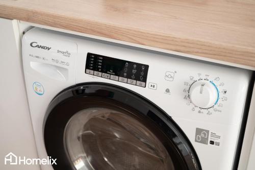 a washing machine with a wooden counter above it at AMAYA - Sea View Suites in Chalkida