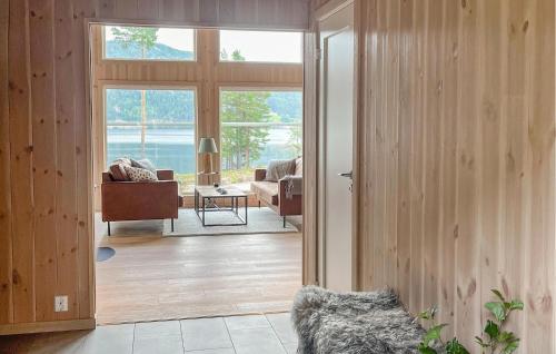 a living room with a door open to a living room with a view at Lovely Home In Treungen in Fjone