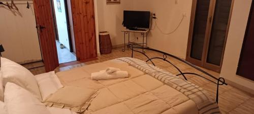 a bedroom with a bed with a towel on it at Casa Matì in Trecastagni