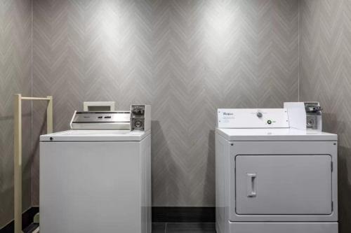 two machines and a washer and dryer in a room at Comfort Inn & Suites Pauls Valley - City Lake in Pauls Valley