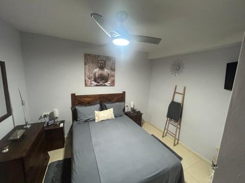 a bedroom with a bed and a ceiling fan at Casa Gloria in Los Abrigos