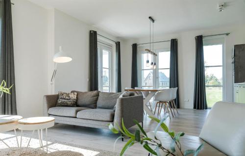 a living room with a couch and a table at Cozy Apartment In Kamperland in Kamperland