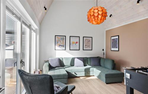 a living room with a couch and a table at Lovely Home In Væggerløse With Sauna in Marielyst