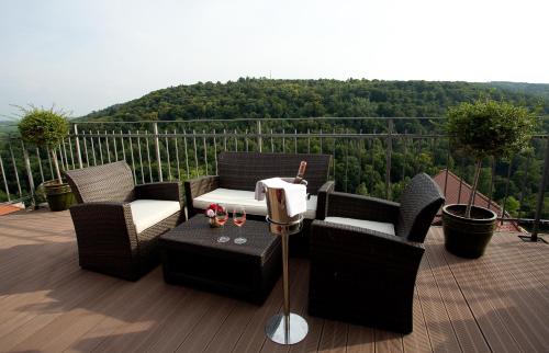 a deck with chairs and a table with a view at Alte Pfarrey in Neuleiningen