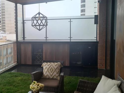 a balcony with a chair and a pendant light at Miraflores habitación separada con privacidad dentro de departamento compartido in Lima