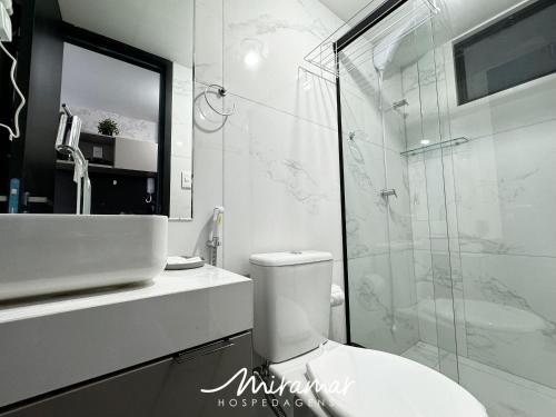 a bathroom with a shower and a toilet and a sink at Move - Tambaú in Tambaú