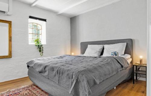 a bedroom with a large bed in a white room at Beautiful Home In Grenaa With Wifi in Grenå